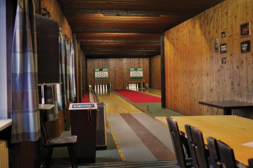 a room with a table and chairs and a room with wooden walls at Landhotel Gottinger in Waldkirchen