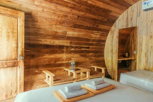 a room with a bed and a table in it at Phu Quoc Valley Sen Bungalow in Phu Quoc