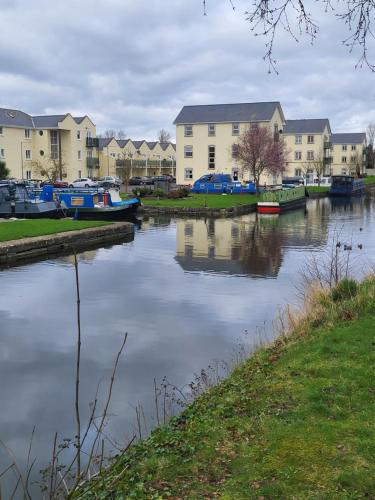 a group of boats are docked on a river at Fearmore view in Kildare