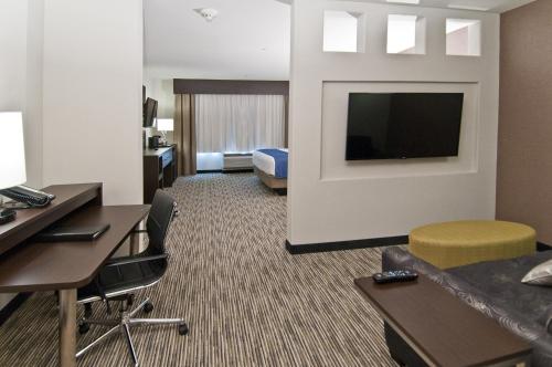 a hotel room with a bed and a flat screen tv at Holiday Inn Austin Airport by IHG in Austin