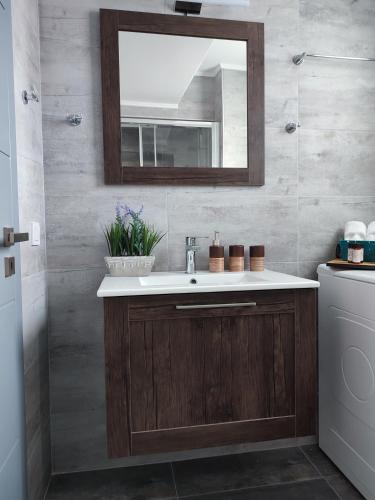 a bathroom with a sink and a mirror at A&G Luxury House in Porto Heli