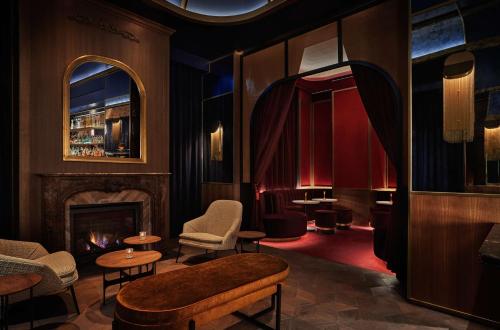 a room with a fireplace and chairs and a fire place at Pendry Washington DC - The Wharf in Washington