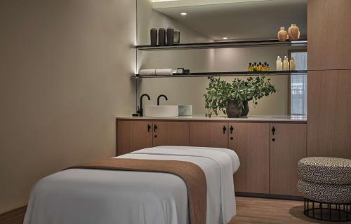 a room with a bed and a kitchen with a sink at Pendry Washington DC - The Wharf in Washington