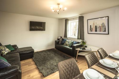 a living room with a couch and a table at Upton Grange Townhouse in Chester