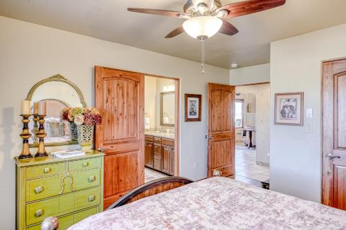 a bedroom with a dresser and a ceiling fan at Casa del Sol Naciente in El Prado