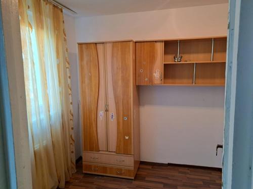 a room with wooden cabinets in a room at Apartament Amurg in Dej