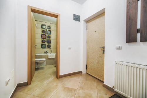 a bathroom with a sink and a toilet in a room at Green Studio - located by the forest, near AFI Mall, and moments away from The Old Town in Braşov