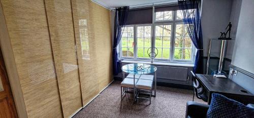 a room with a table and a chair and a window at 206mm Highgate Apartment in London