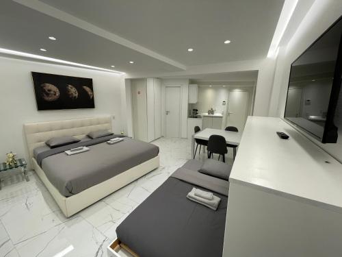 a bedroom with a bed and a dining room at TALEDA Apartments - Modern Apartments & Self Checkin in the Old Town in Lugano