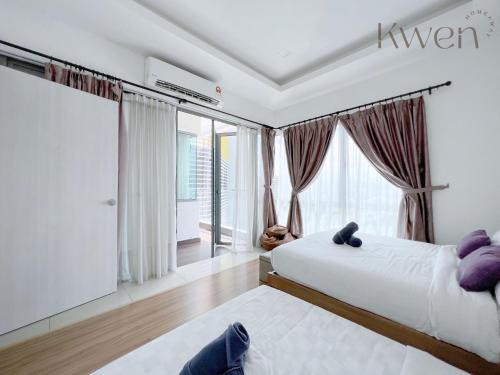 a bedroom with two beds and a large window at KWEN Loft - City Centre Imago 3BR l 2BR l Studio in Kota Kinabalu