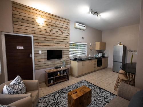 a living room with a refrigerator and a kitchen at Little Eden St Lucia in St Lucia