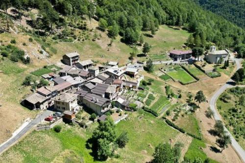 an aerial view of a house on a hill at La casetta delle bambole. in Massello