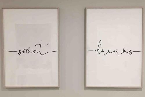 two framed signs on a wall with the words street dreams at Shimna Vale Studio in Newcastle