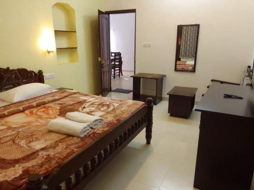 a bedroom with a bed with towels on it at Royal Serene Villas in Ooty