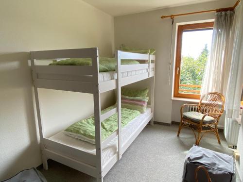 two bunk beds in a room with a window at Auszeit in Immenstaad am Bodensee
