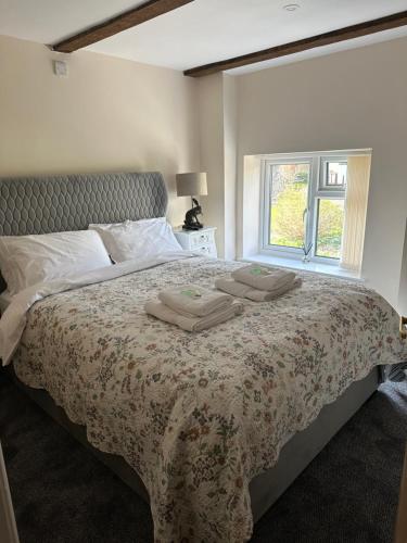 a bedroom with a bed with two towels on it at The Nags Head - Room only accommodation in Lyme Regis