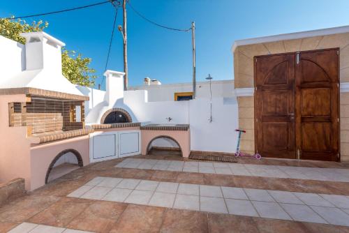 a patio with a wooden door and a building at Casa Aestas in Lachania