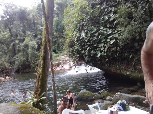 a group of people swimming in a river at Pouso Paraty in Paraty
