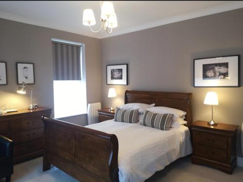 ダブリンにあるShaw Suiteのベッドルーム1室(ベッド1台、ナイトスタンド2台、ランプ2つ付)
