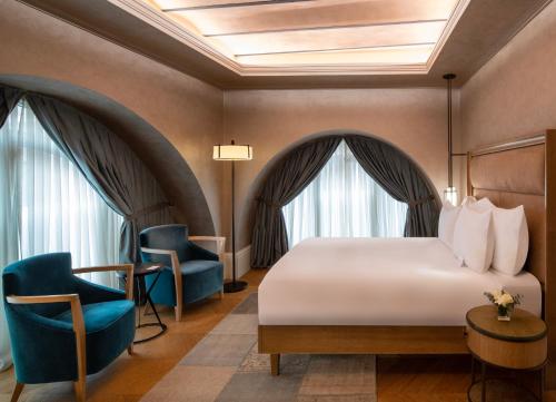 a hotel room with a bed and two chairs at 10 Karakoy in Istanbul