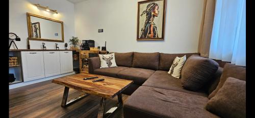 a living room with a couch and a coffee table at Апартамент Bella Casa in Beli Iskar