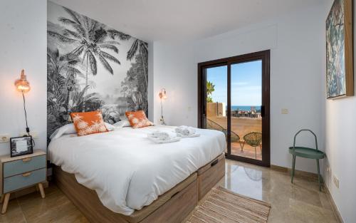 a bedroom with a large bed with a large window at Coto Real 2412 KHIOS in San Luis de Sabinillas