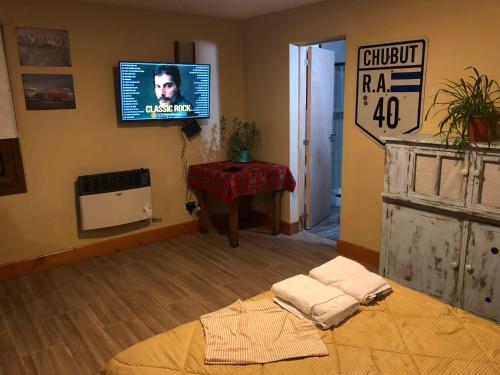 a living room with a tv on the wall at Santa Clara in San Carlos de Bariloche