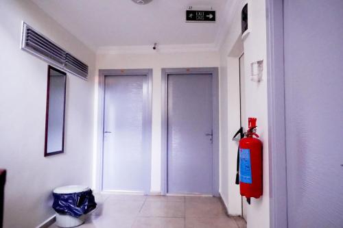 a hallway with two doors and a red fire hydrant at Hotel Resat in Izmir