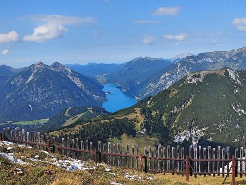 a fence on top of a mountain with a lake at Guffertblick in Achenkirch