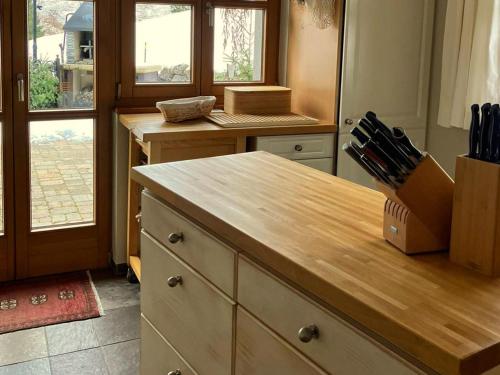 a kitchen with a counter with a knife block on it at Guffertblick in Achenkirch