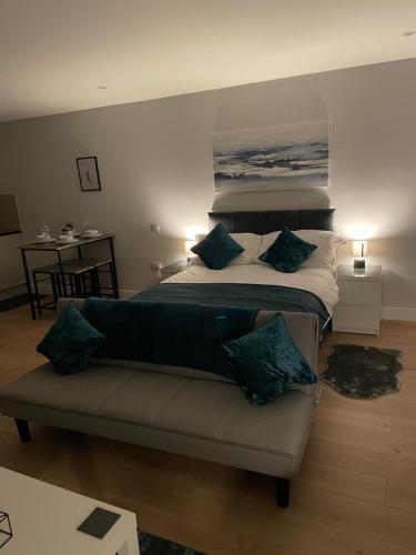 a bedroom with a large bed and a couch at Super-King Bed Studio Apartment in Central Northampton in Northampton