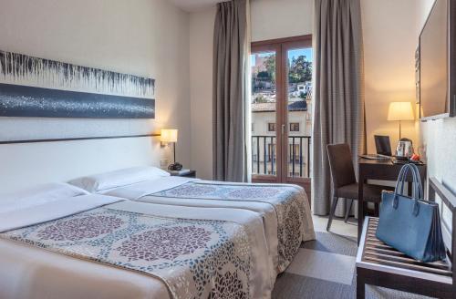 Cama o camas de una habitación en Hotel Macià Plaza