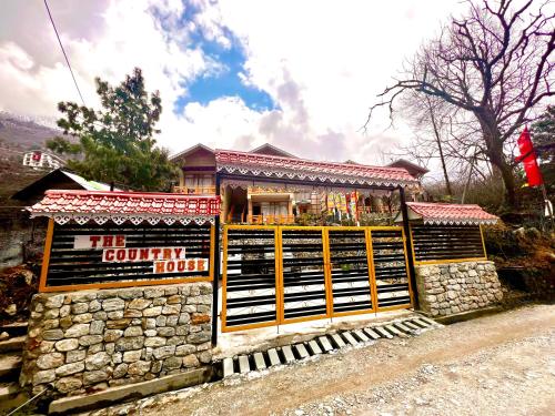 a building with a sign in front of it at The Country House by Trekocity in Lachung