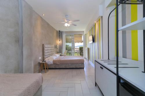 A bed or beds in a room at Porto Palio Beach Hotel