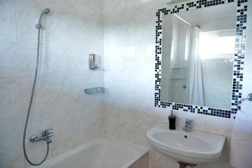 a bathroom with a tub and a sink and a shower at Liza Aqua & Conference Hotel in Lajosmizse