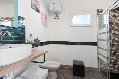 a bathroom with a sink and a toilet at Casa Vieja in Puerto del Rosario