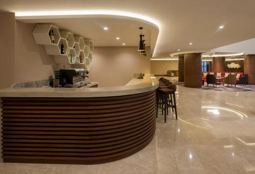 a lobby with a bar in a hotel at The Superior Living Batışehir in Istanbul