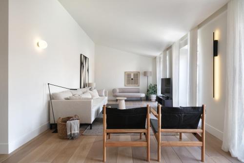a living room with two chairs and a couch at Villa Sofia Cascais in Cascais