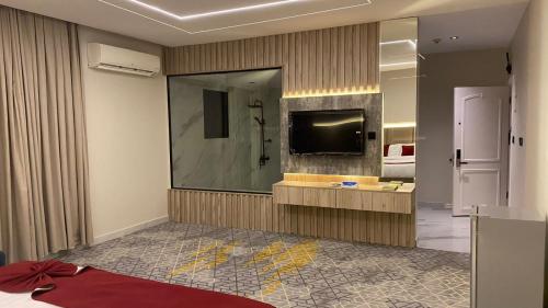 a hotel room with a large mirror and a television at Golden New Al Safa in Jeddah
