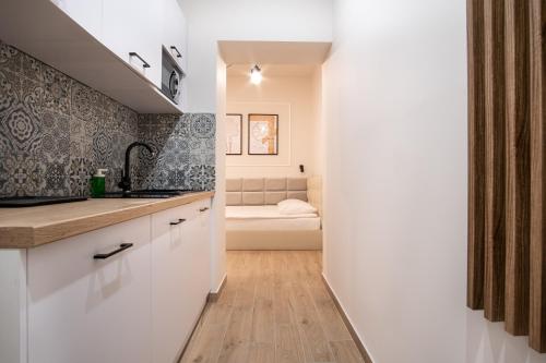 a kitchen with a sink and a couch in a room at Dream Apartments - Gdańska 72 in Łódź