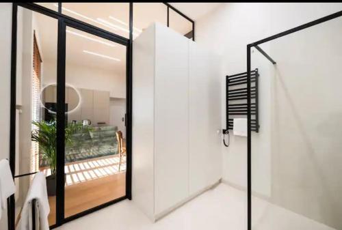 a pivot door in a bathroom with white walls at Palace of Culture Loft Apartment in Warsaw