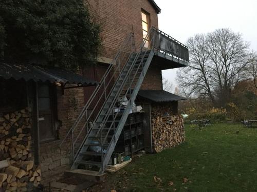 a ladder on the side of a brick building at ziggy's room with a view in Heyd