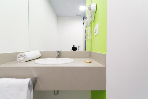 a bathroom with a sink and a mirror at ibis Styles Sao Paulo Barra Funda in Sao Paulo