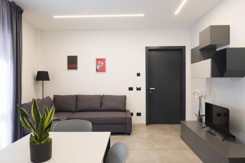 a living room with a couch and a tv at Amiata Suite in Abbadia San Salvatore