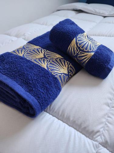 two blue towels are laying on a bed at Green Surf House in Agadir