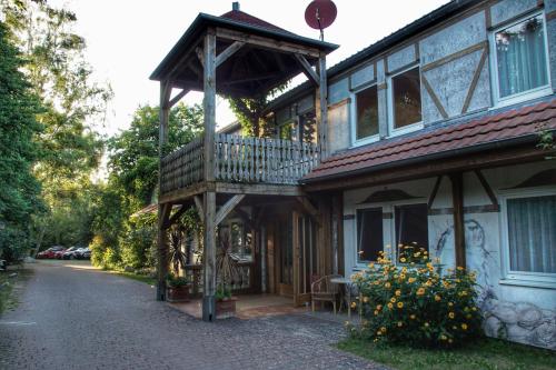 a house with a balcony on the side of a street at Romantischer Seegasthof & Hotel Altes Zollhaus in Feldberg