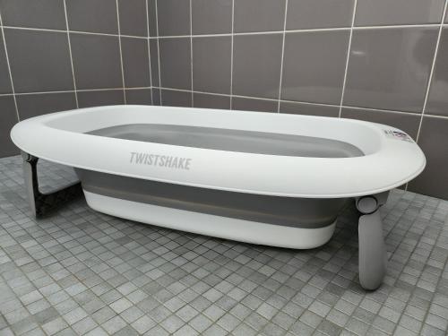 a bath tub sitting in a bathroom stall at Maison Les Embruns avec piscine collective in La Faute-sur-Mer