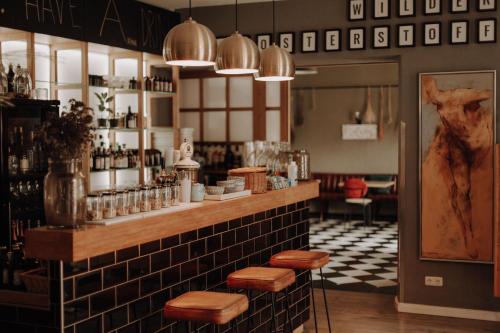a restaurant with a bar with stools on the counter at Klosterhotel Neuzelle in Neuzelle