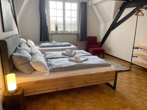 a bedroom with two beds with towels on them at Hotel Schloss Walbeck in Geldern