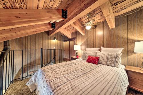 a bedroom with a large bed with wooden walls at Pinecrest Retreat with Fireplace! in Pinecrest